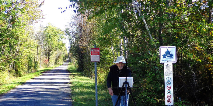 David Kearn painting outside on the trail