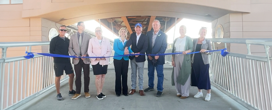 Trans Canada Trail CEO Eleanor Mcmahon and trail network members cutting a blue ribbon on the River Valley Alliance bridge