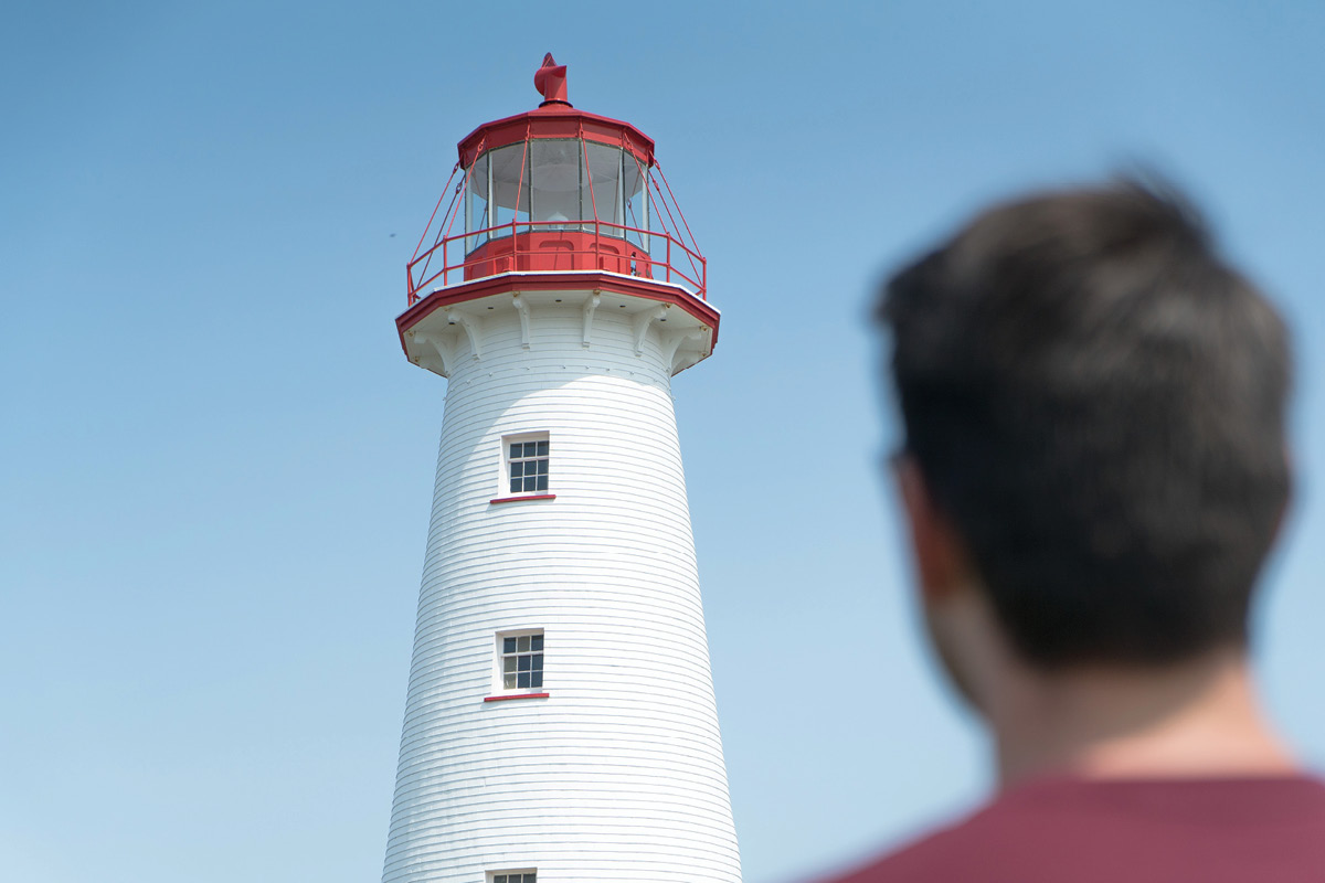 Someone looking up at a lighthouse