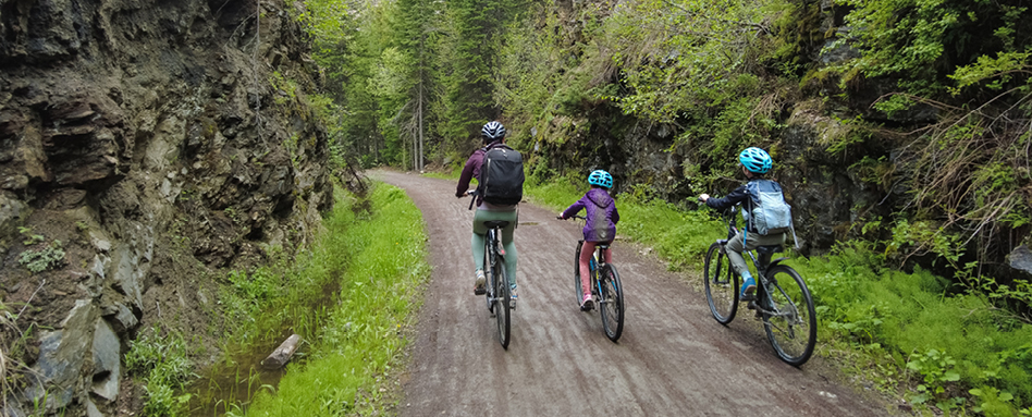 A family riding their bikes on a Kelowna trail | Une famille faisant du vélo sur un sentier de Kelowna