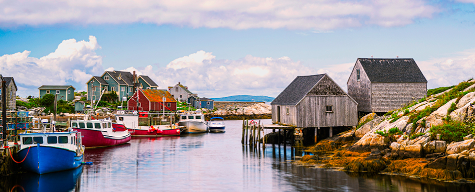 Peggys Cove dock: A picturesque wooden dock extending into the calm blue waters, surrounded by rocky cliffs and a charming coastal village. | 