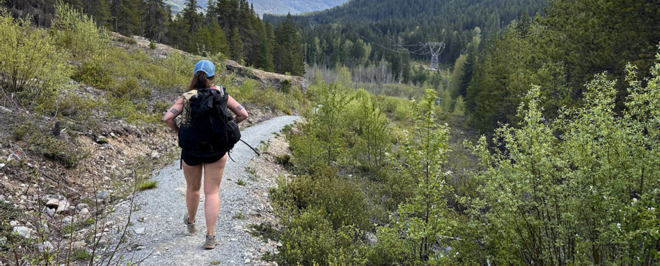 woman walking along hiking trail