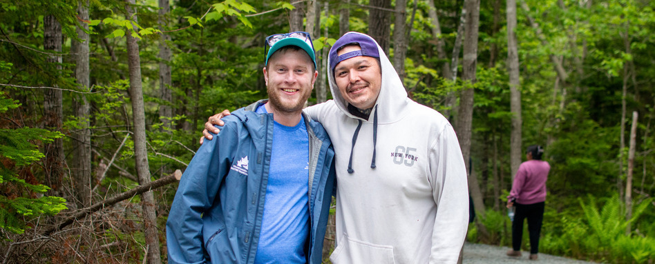 NS - Forrest of Hope Trail Potlotek | Sentier Transcanadien two men posing for a photo in a forest