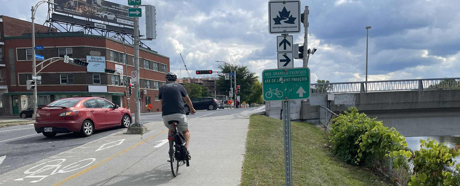 people biking down a trail in a city