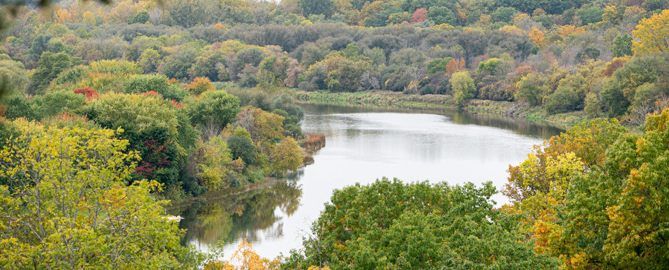 birdseye view of river and fall foliage surrounding