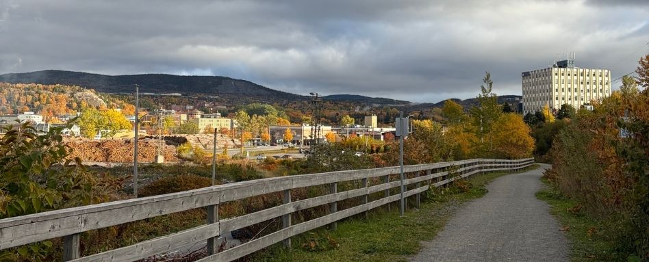 trail wooden signage with hills in behind