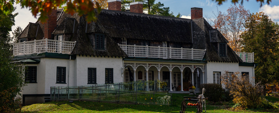 large mansion with wrap around on sunny day