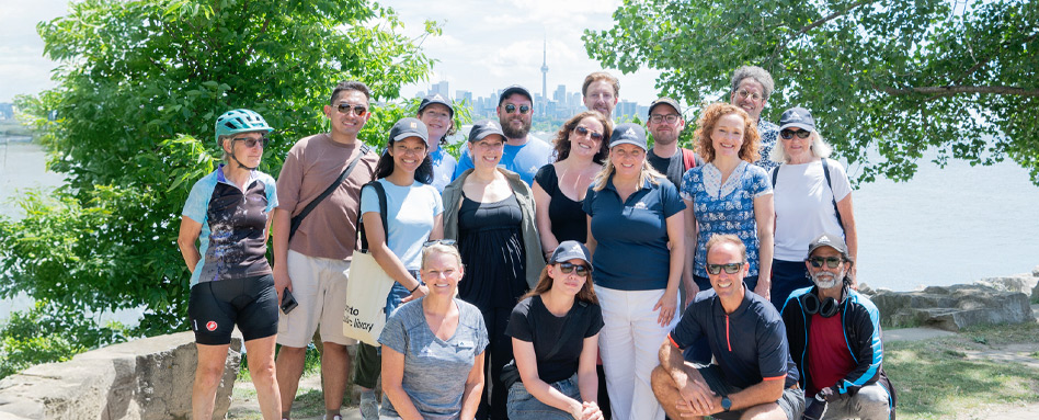 people on a sunny day standing with CN tower in rearview 