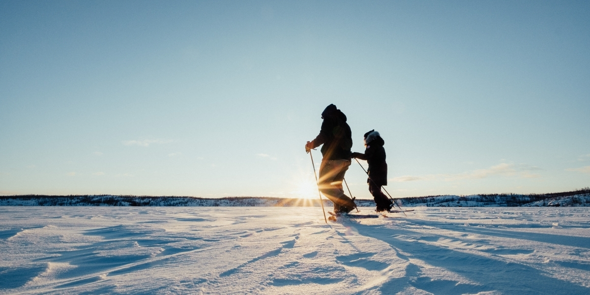 two people on cross country skies in the snow on a sunny day