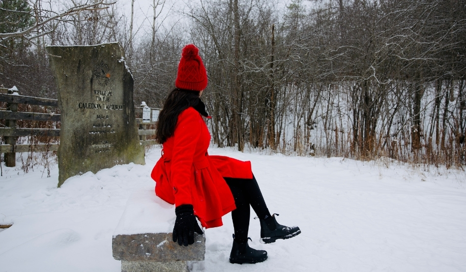 woman sitting on a rock in the snow 