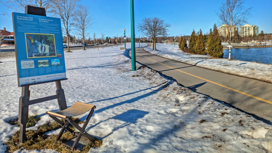 snowty trail with wooded area on sunny day