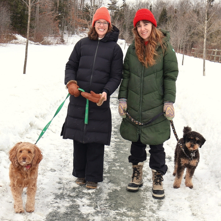 05Support image_HRM web story_Dog walkers_credit Cathy Donaldson | Sentier Transcanadien two girls walking dogs smiling on a snowy trail