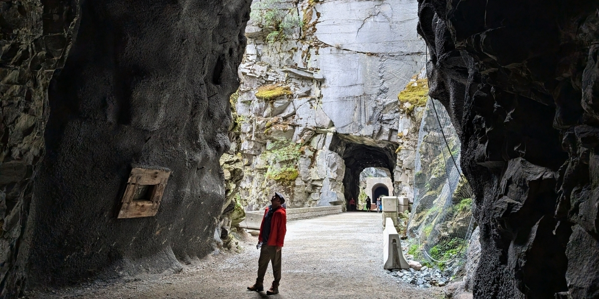 00Feature image_BC_Othello Tunnels_credit Gemma Taylor - Off Track Travel | Sentier Transcanadien woman looking up at rock tunnels