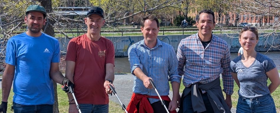 group of people holding track sticks smiling on a sunny day