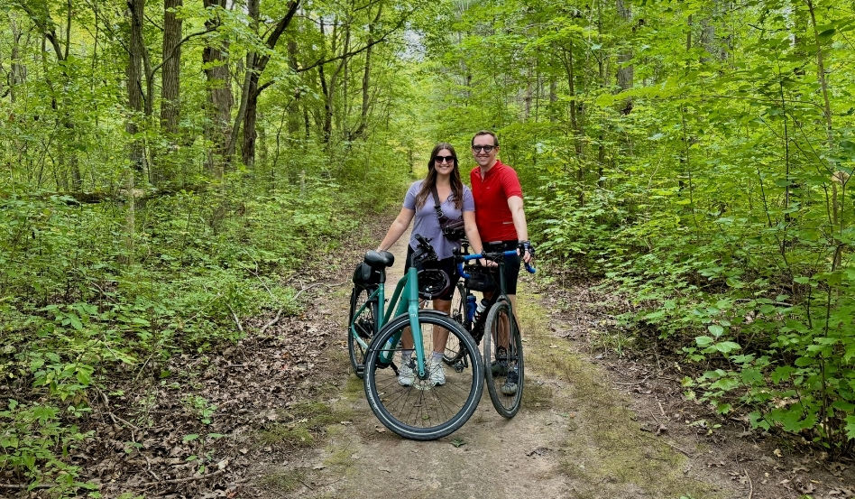 man and woman posing with bikes