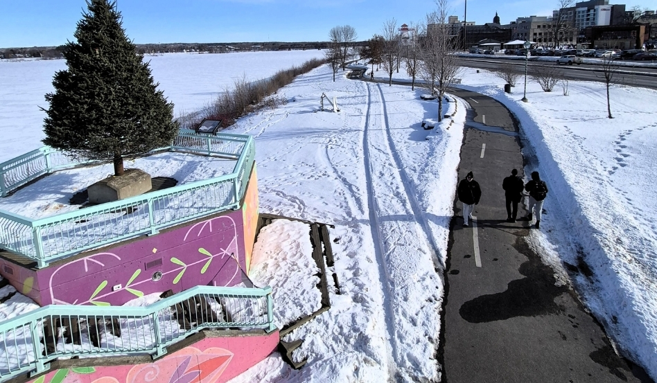 birdseye of people walking on a winter trail on a sunny day