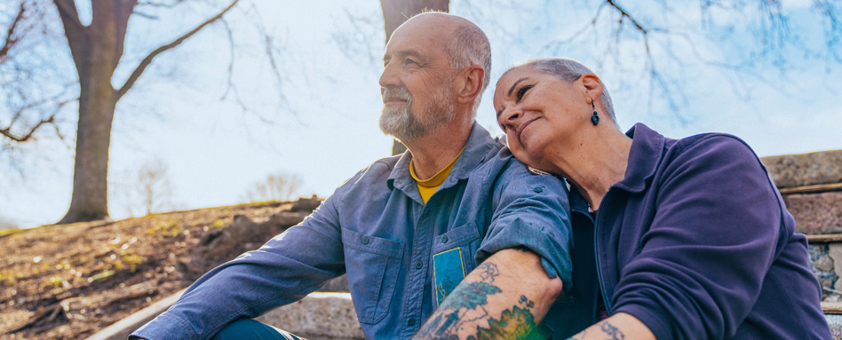 two people embracing and smiling looking forward