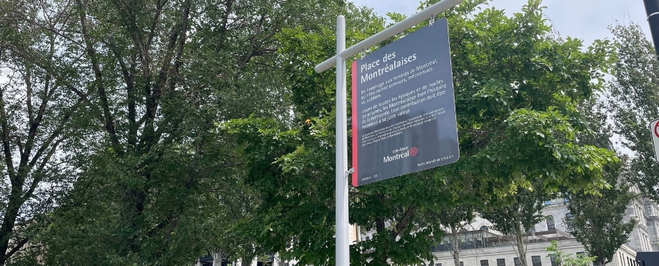 Informational sign mounted on a lamppost beside a tree-lined street, with French text including 'Place des Montréalaises'.